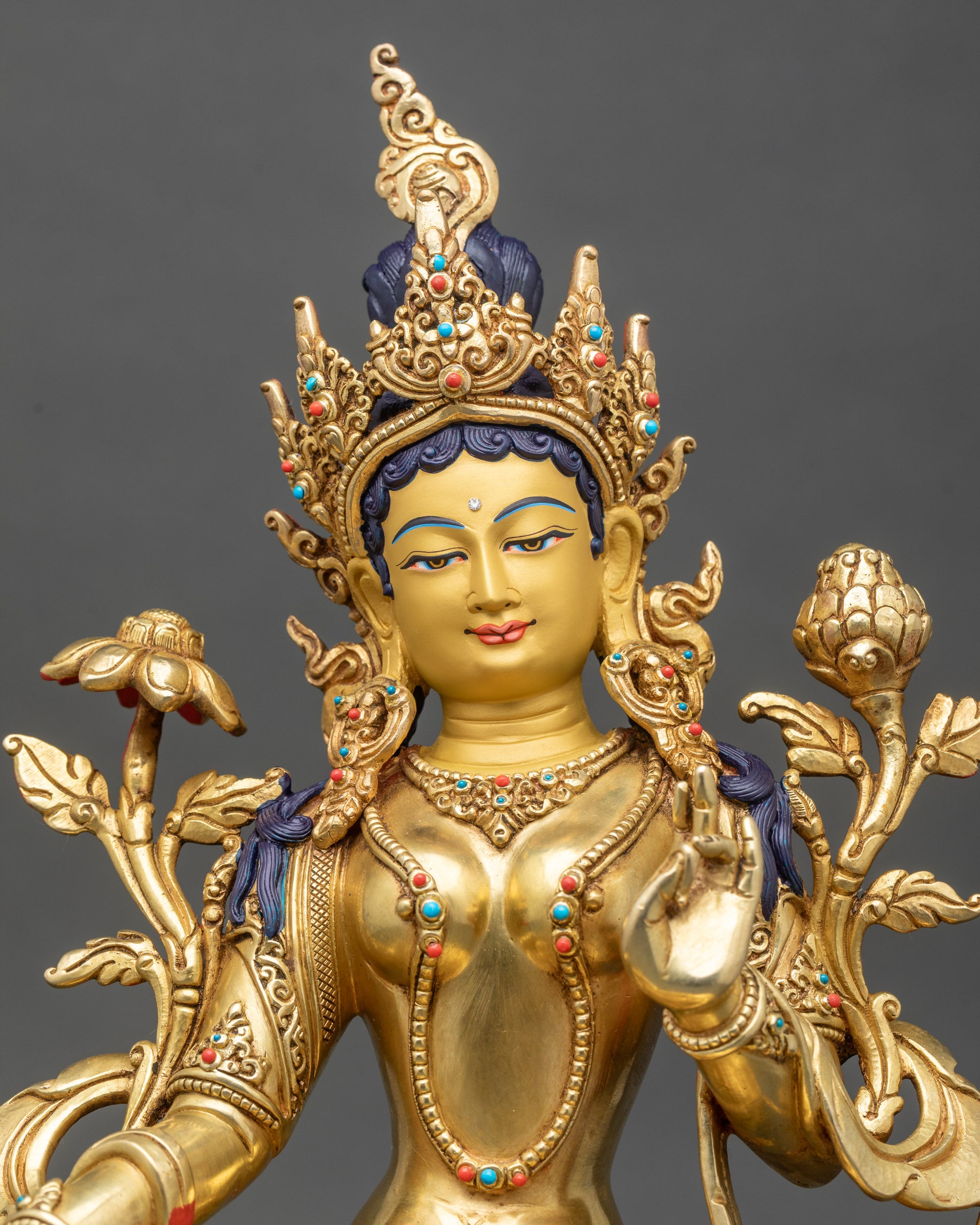 Green Tara deity statue with gold-painted face, five-jeweled crown, and intricate stone inlays