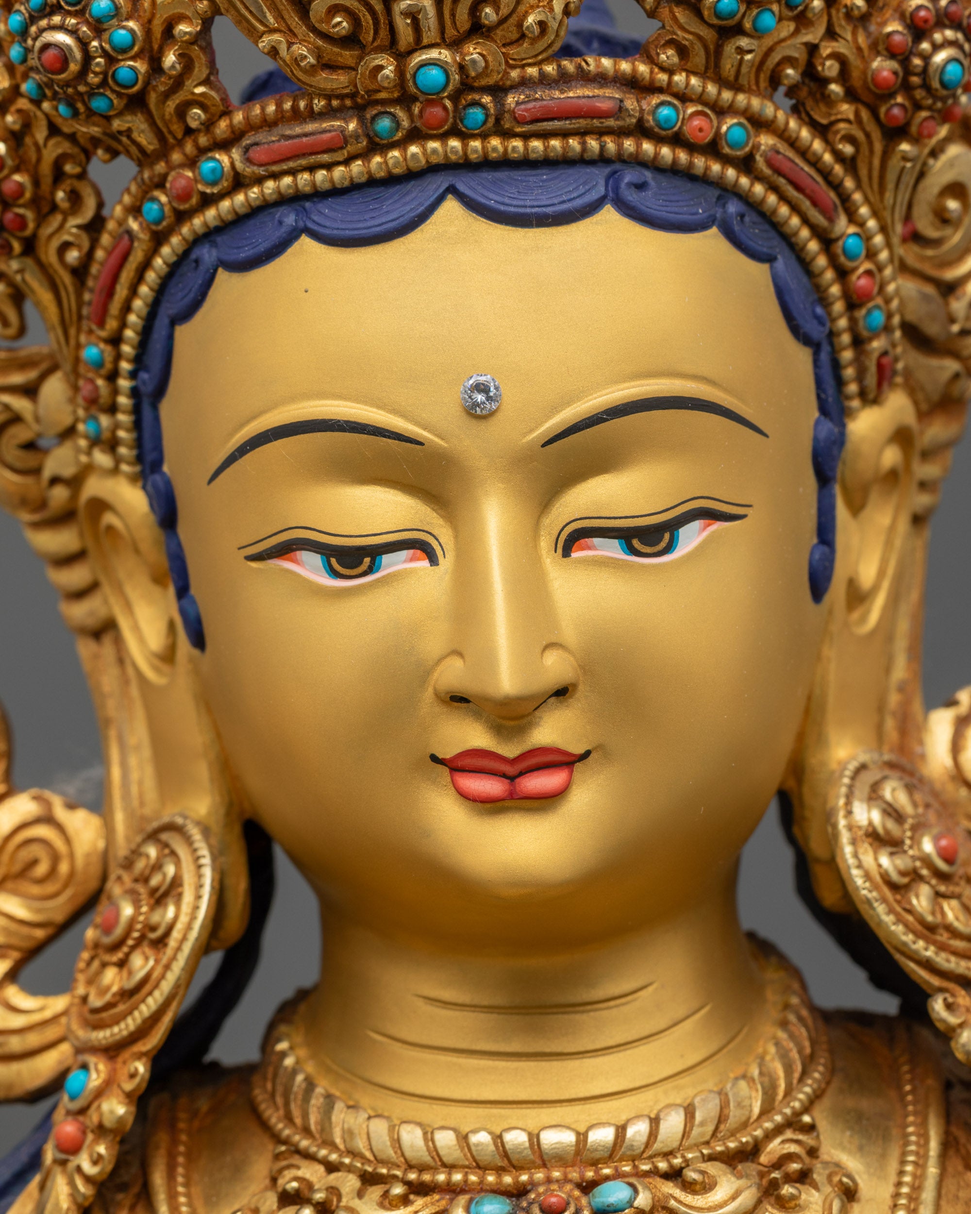 Green Tara detailed close up face highlighting serene expression and floral patterned robes