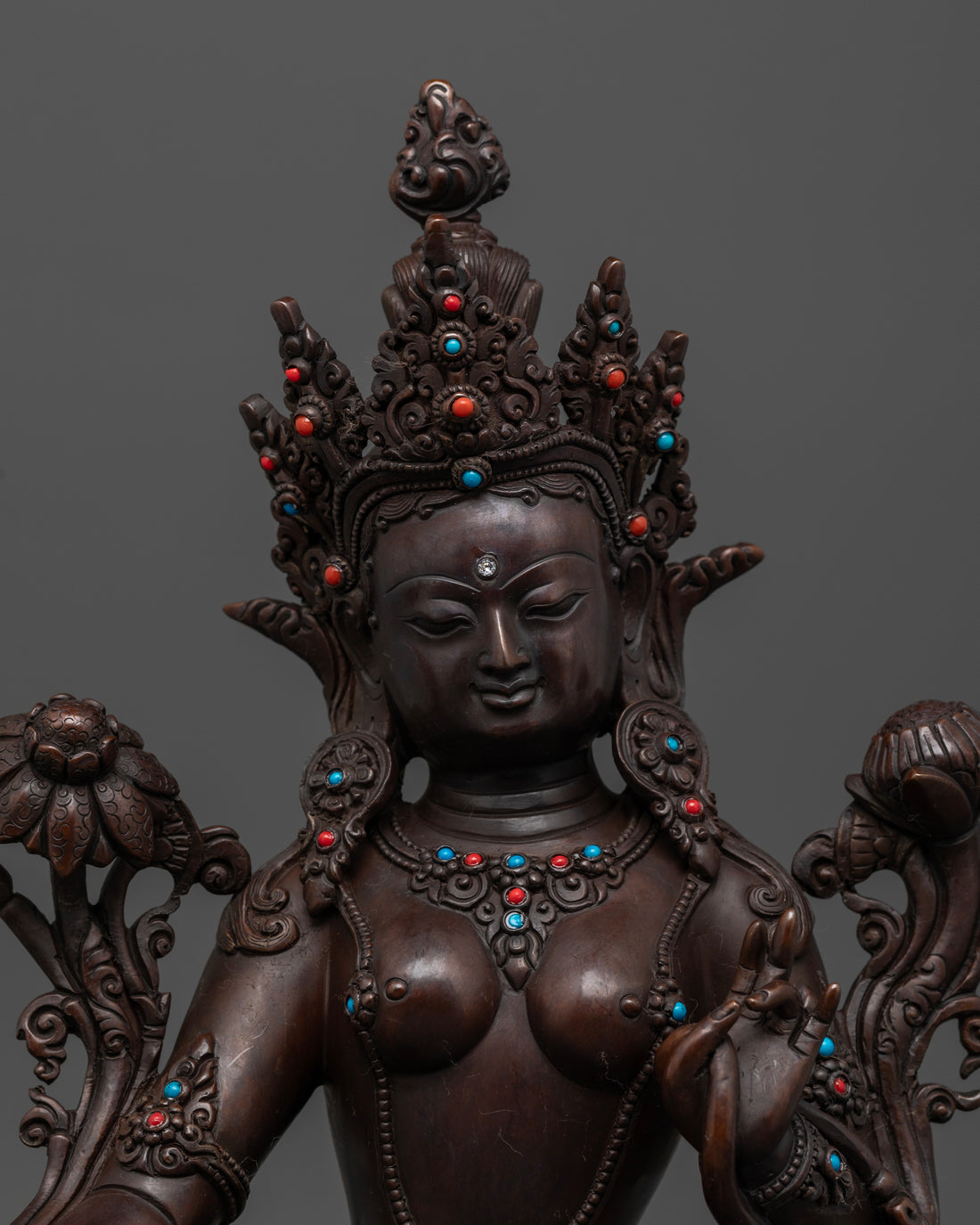 Face of oxidized brown Green Tara statue