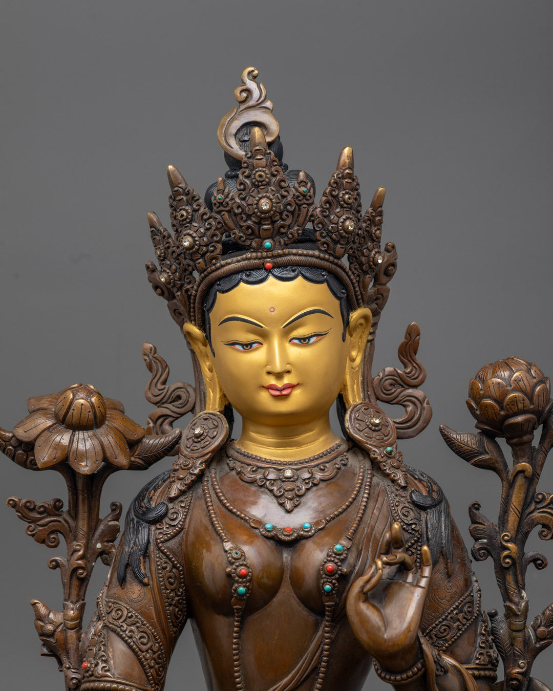 Green Tara’s ornate crown, hand-carved jewelry, and semi-precious stone inlays