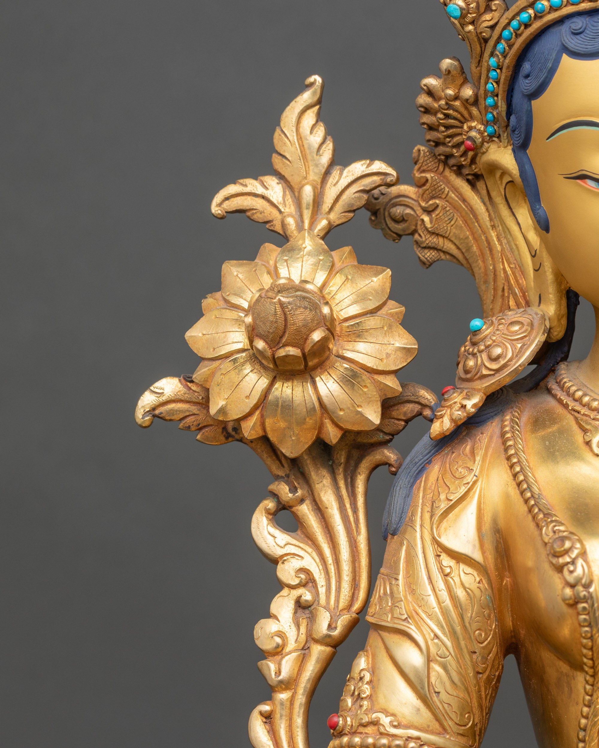 Green Tara seated on double lotus pedestal holding utpala flower in Varada mudra