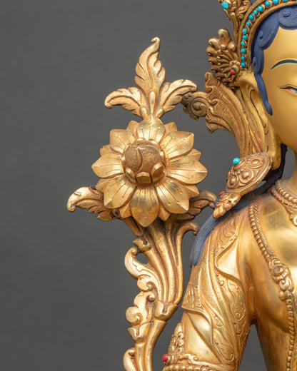 Green Tara seated on double lotus pedestal holding utpala flower in Varada mudra