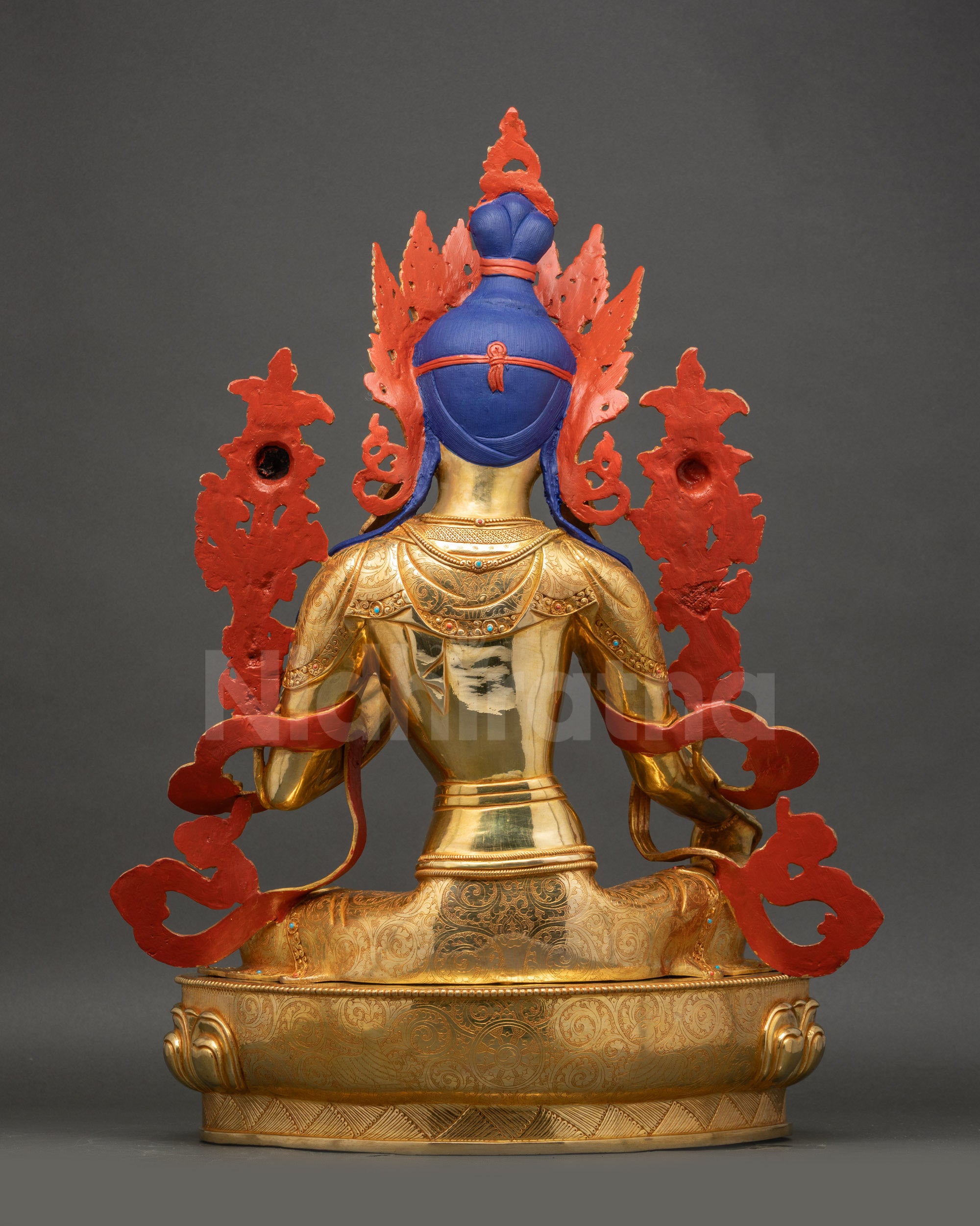 Green Tara statue back view revealing detailed carving and smooth polished copper