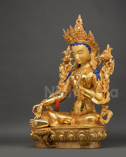 Green Tara statue left side view displaying diadem and flowing carved patterns
