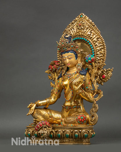 Green Tara statue left side view, intricate gold fire-gilded Bodhisattva details