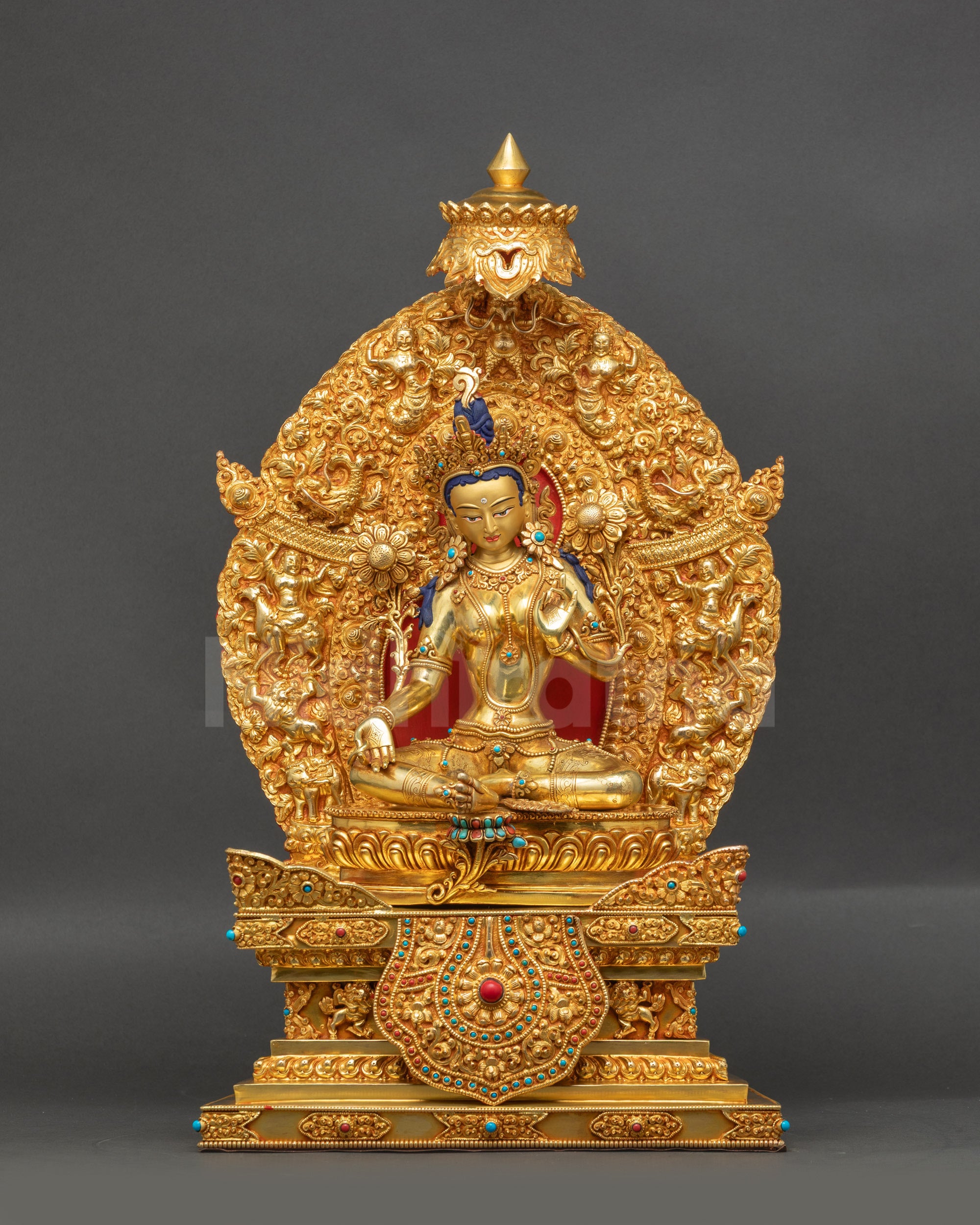 Green Tara statue on gold-gilded Himalayan meditation altar lotus throne