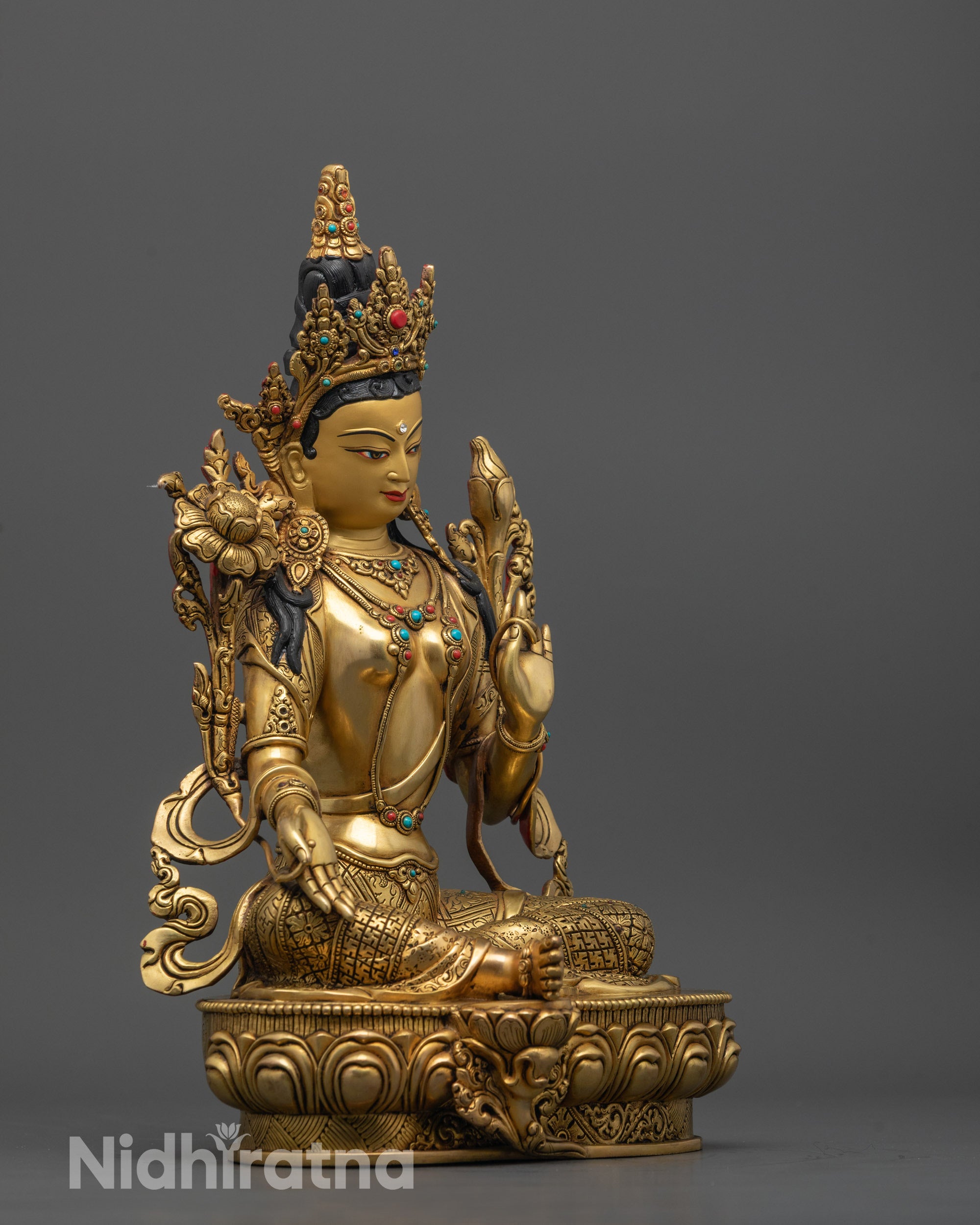Green Tara statue’s face and hand mudra, symbolizing generosity and spiritual protection