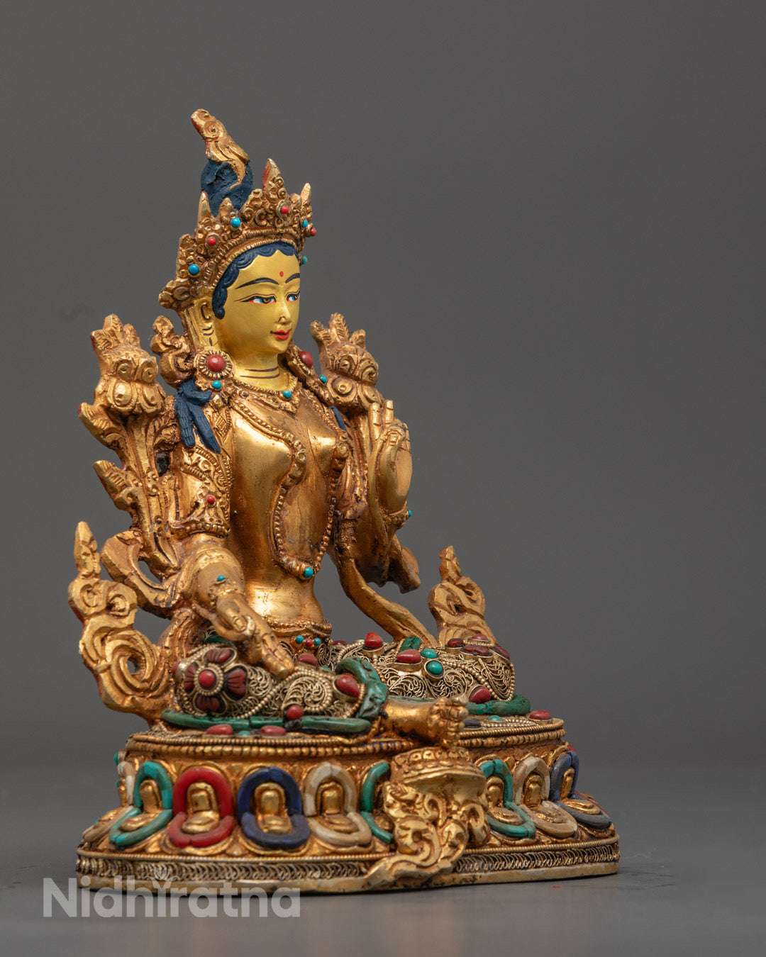 Green Tara statue’s radiant 24k gold-gilded face and intricately carved crown are decorated with semi-precious stones.