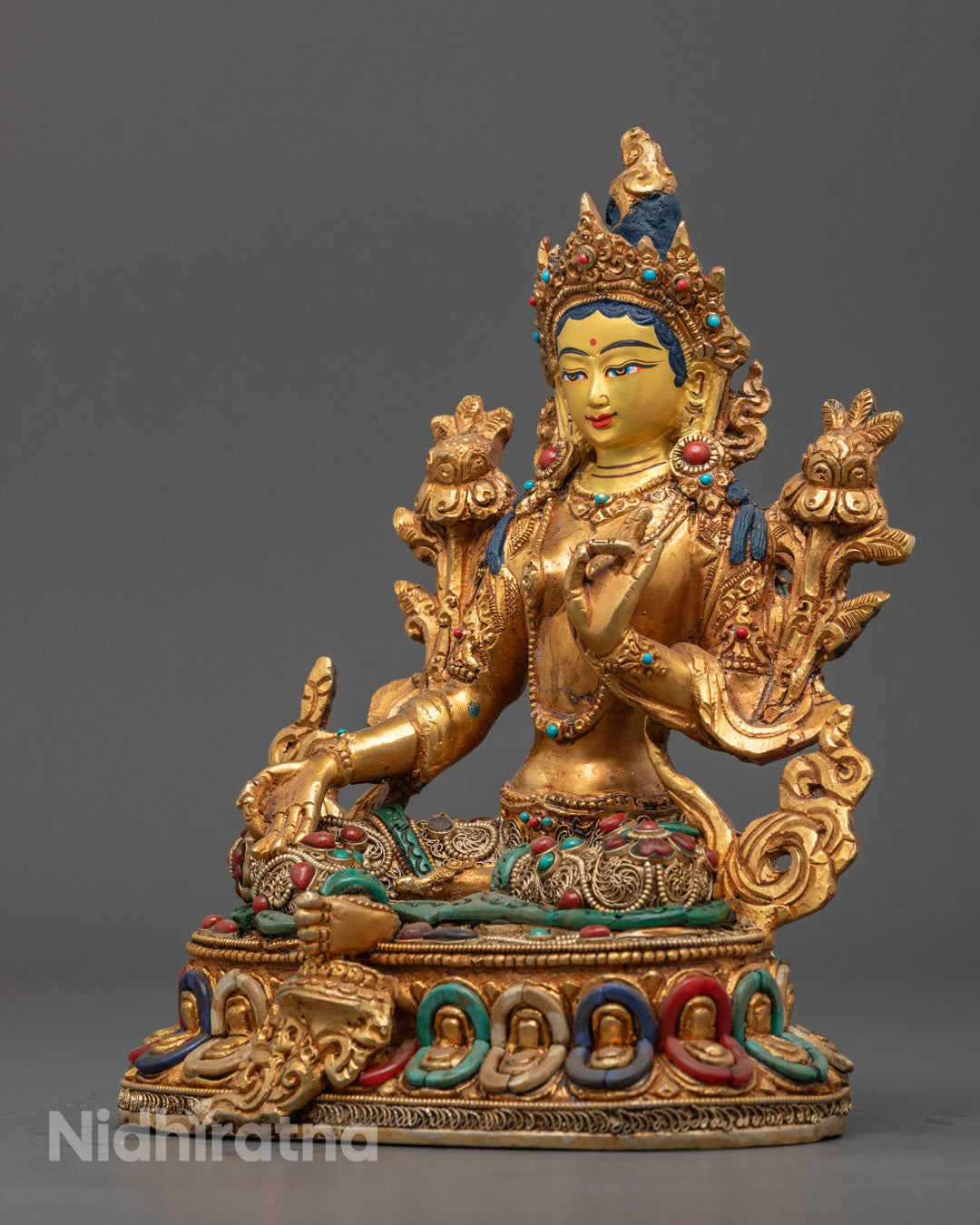 Green Tara statue’s richly carved robe and jewelry embellished with turquoise, coral, and lapis lazuli stones, hand-painted with vibrant acrylic colors.