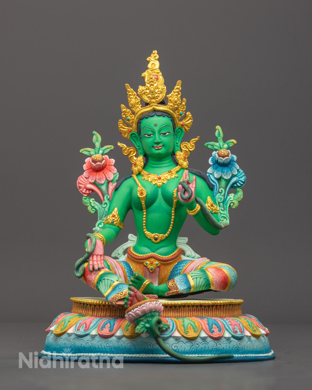 Green Tara statue seated gracefully on lotus throne, hand-carved from copper with vibrant green acrylic colors and gold detailing"