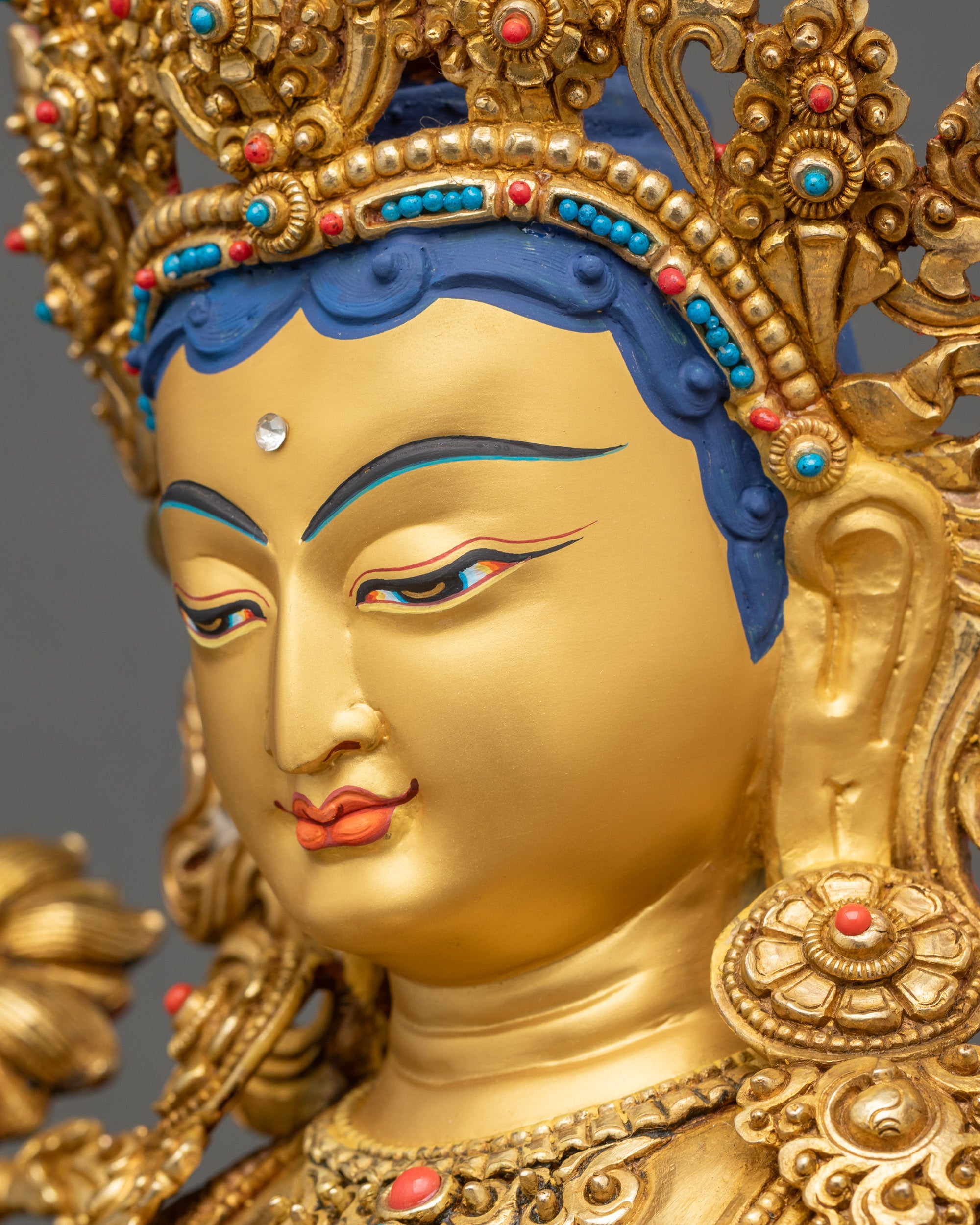 Green Tara statue side face close up gold fire-gilded Himalayan artwork
