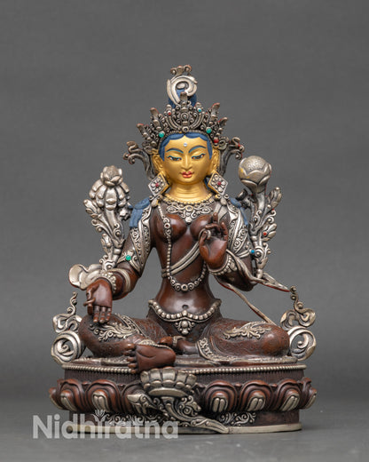 Green Tara statue with 24K gold-painted face and silver-plated body on lotus pedestal