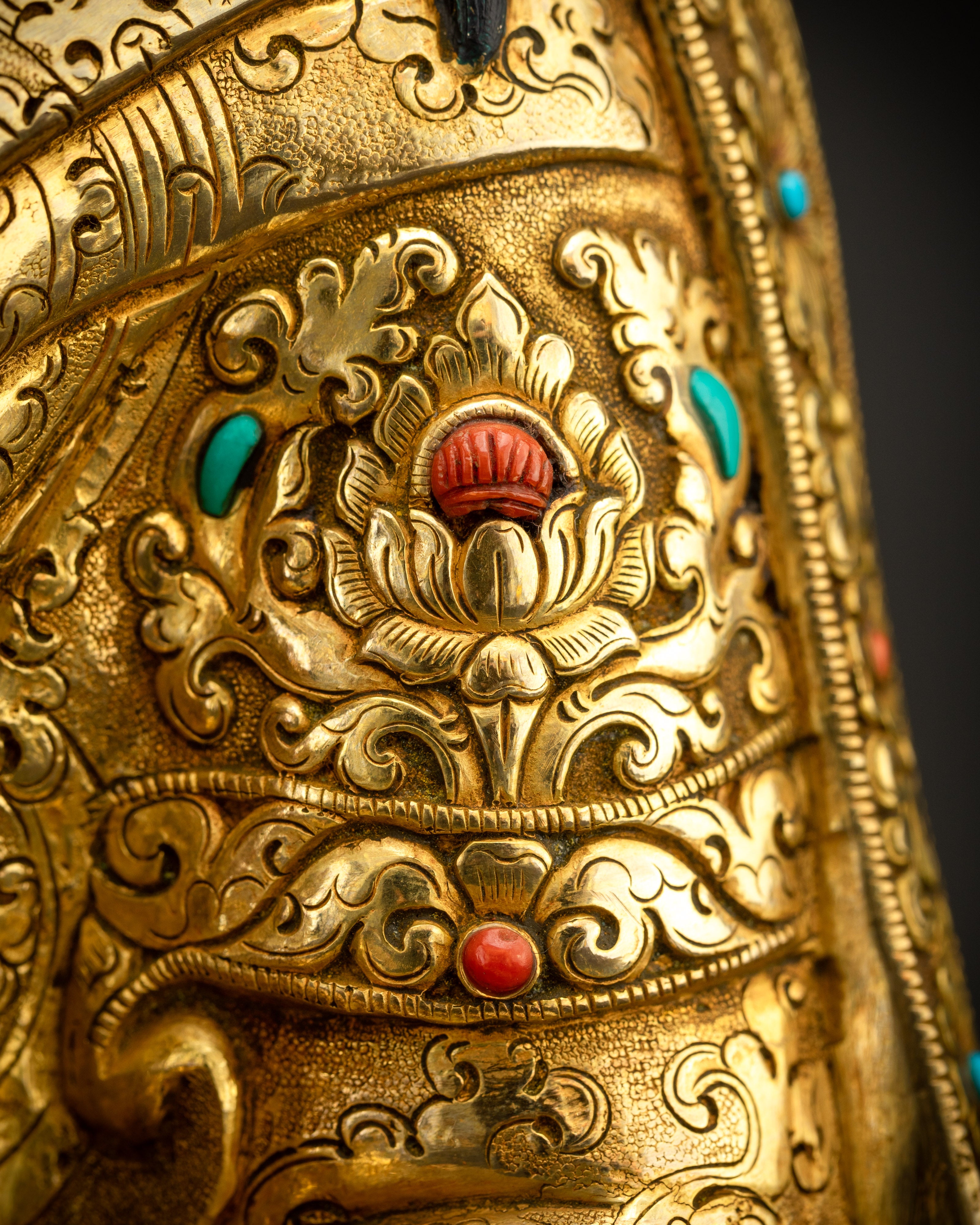 Detailed shot of robe and ornamental stones highlighting vibrant inlays
