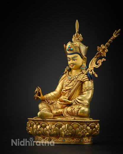 Padmasambhava statue showing the khatvanga staff with three skulls symbolizing transformation of the three poisons.