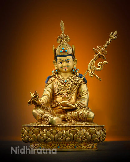 Guru Padmasambhava statue holding vajra and kapala, symbolizing wisdom and immortality.