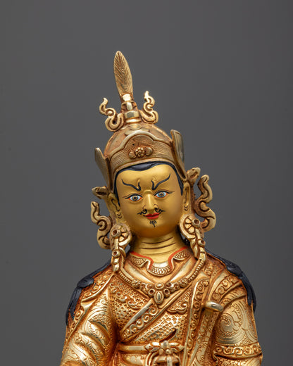 Close-up of Guru Rinpoche’s face with intricate crown and 24k fire gold gilding

