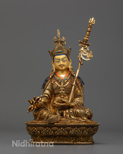 Front view of Guru Rinpoche statue with gold-gilded face and detailed lotus base