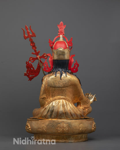 back view of handcrafted Guru Rinpoche statue highlighting lotus seat and carved Dharma Wheel