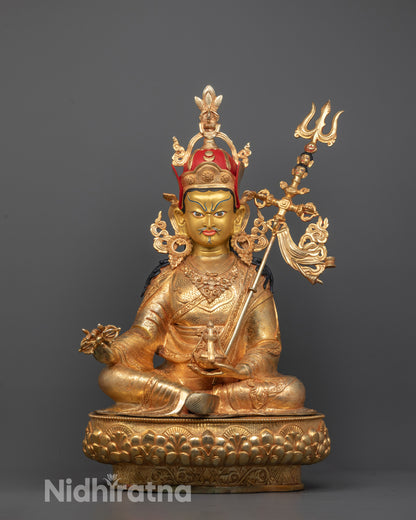 front view of Guru Rinpoche Padmasambhava statue with gold-gilded face and lotus base details
