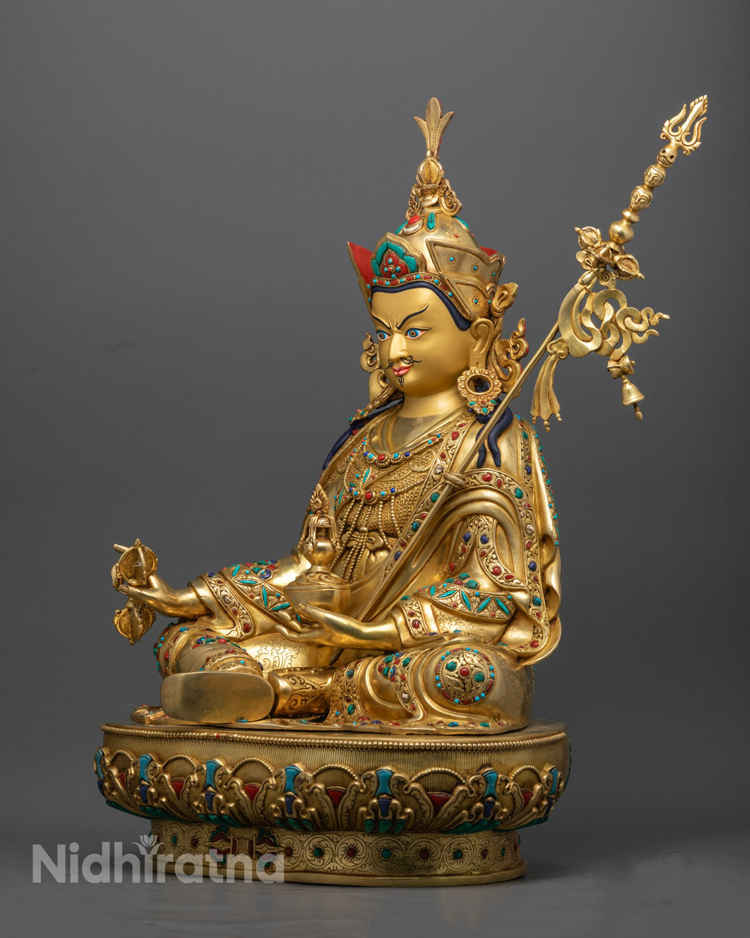 Second Buddha statue seated in meditation posture, with copper-gold brilliance and a hollow consecration chamber visible at the base