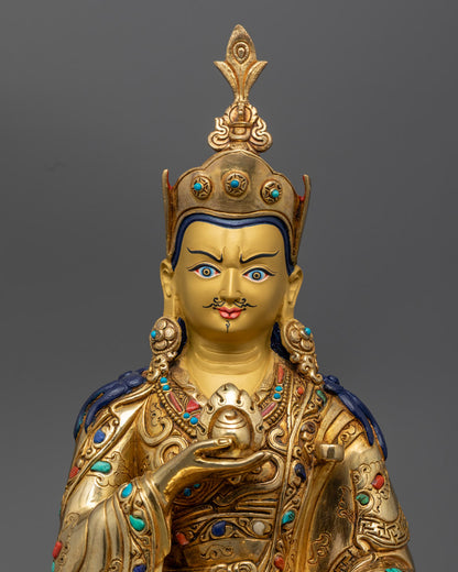 Guru Norla’s face and ornate crown, highlighting detailed craftsmanship and radiant gold finish