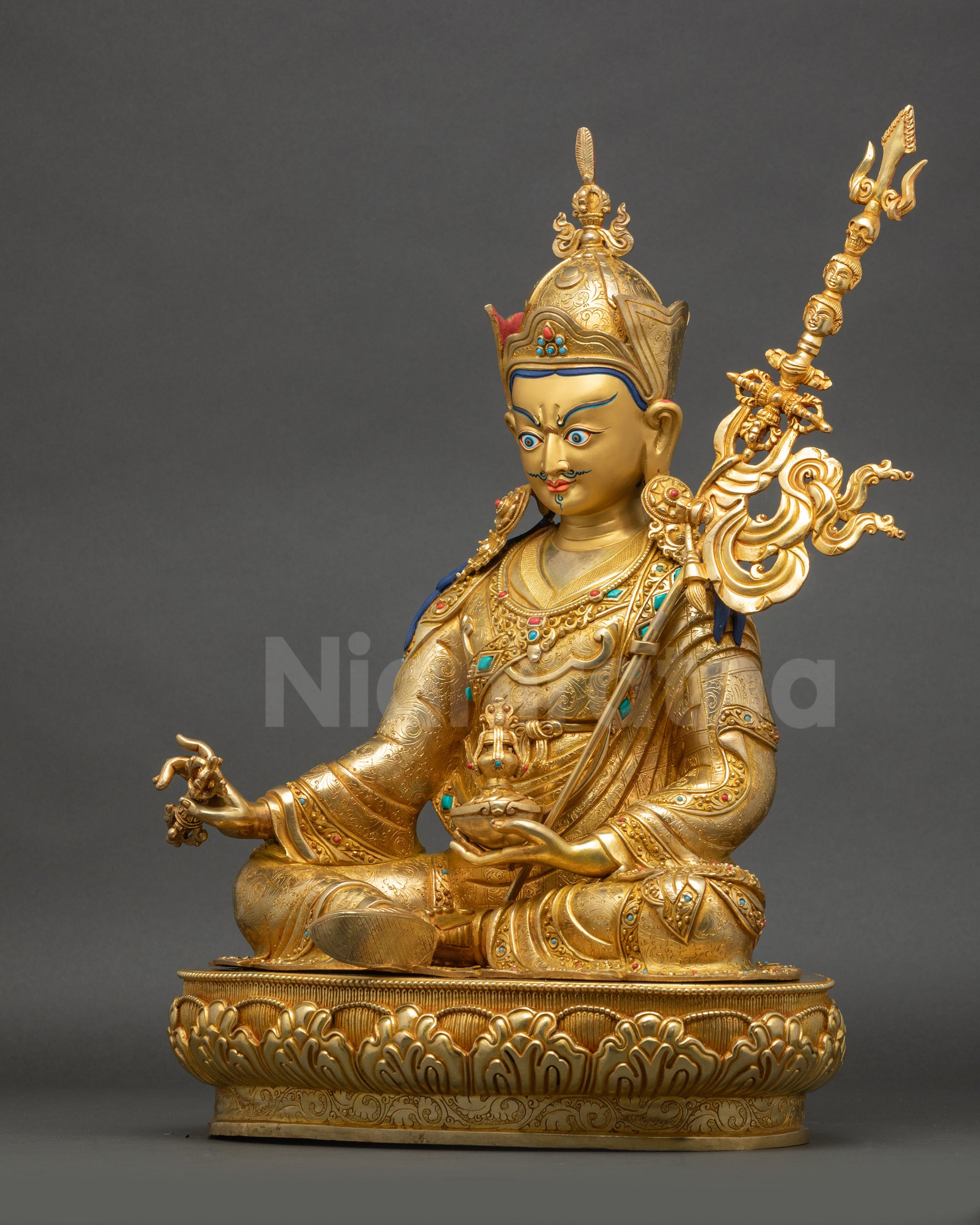 Left view highlighting flowing kasaya robe and intricate carvings on Nepalese Guru Rinpoche statue