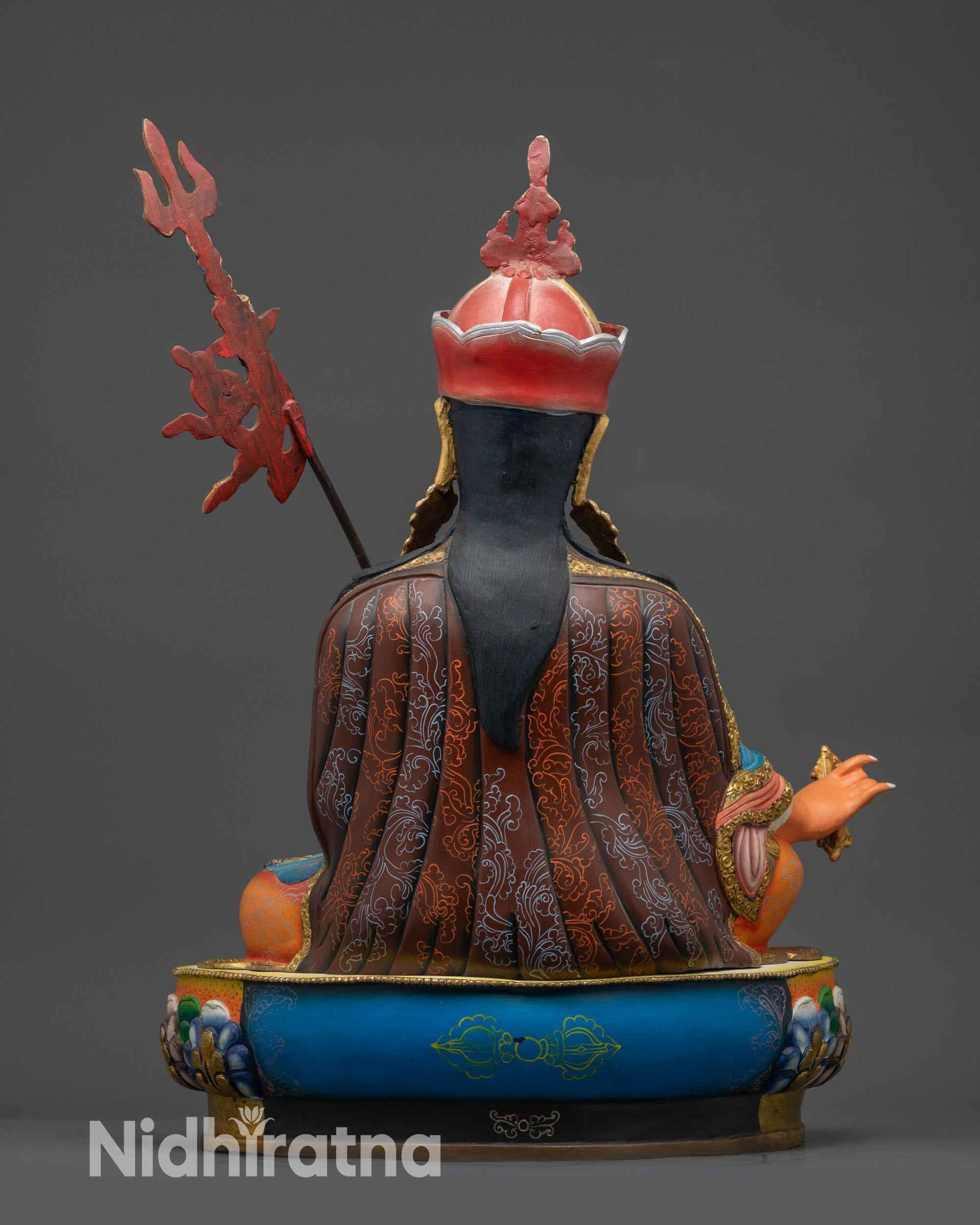 Guru Padmasambhava Statue back view with detailed carvings and painted garments