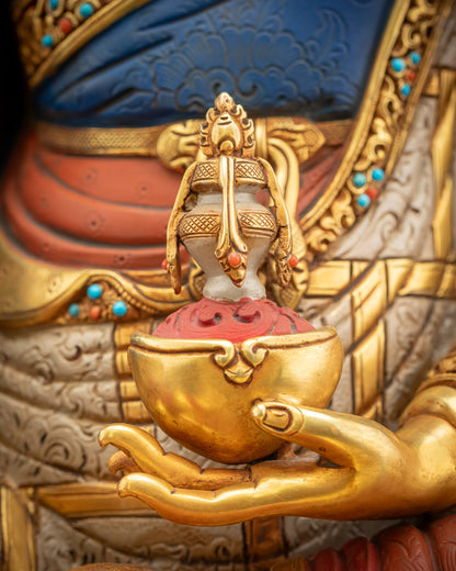 Close-up of Kapala skull cup in Guru Rinpoche statue, hand-carved with gold and vibrant colors.