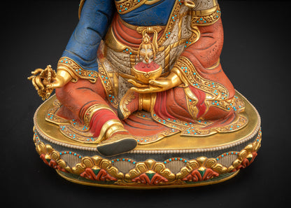 Lower landscape front view of Guru Rinpoche, showing lotus base, robe, and hand placement.