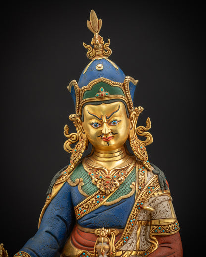 Close-up of Guru Rinpoche statue showing overall copper craftsmanship and gold-accented details.