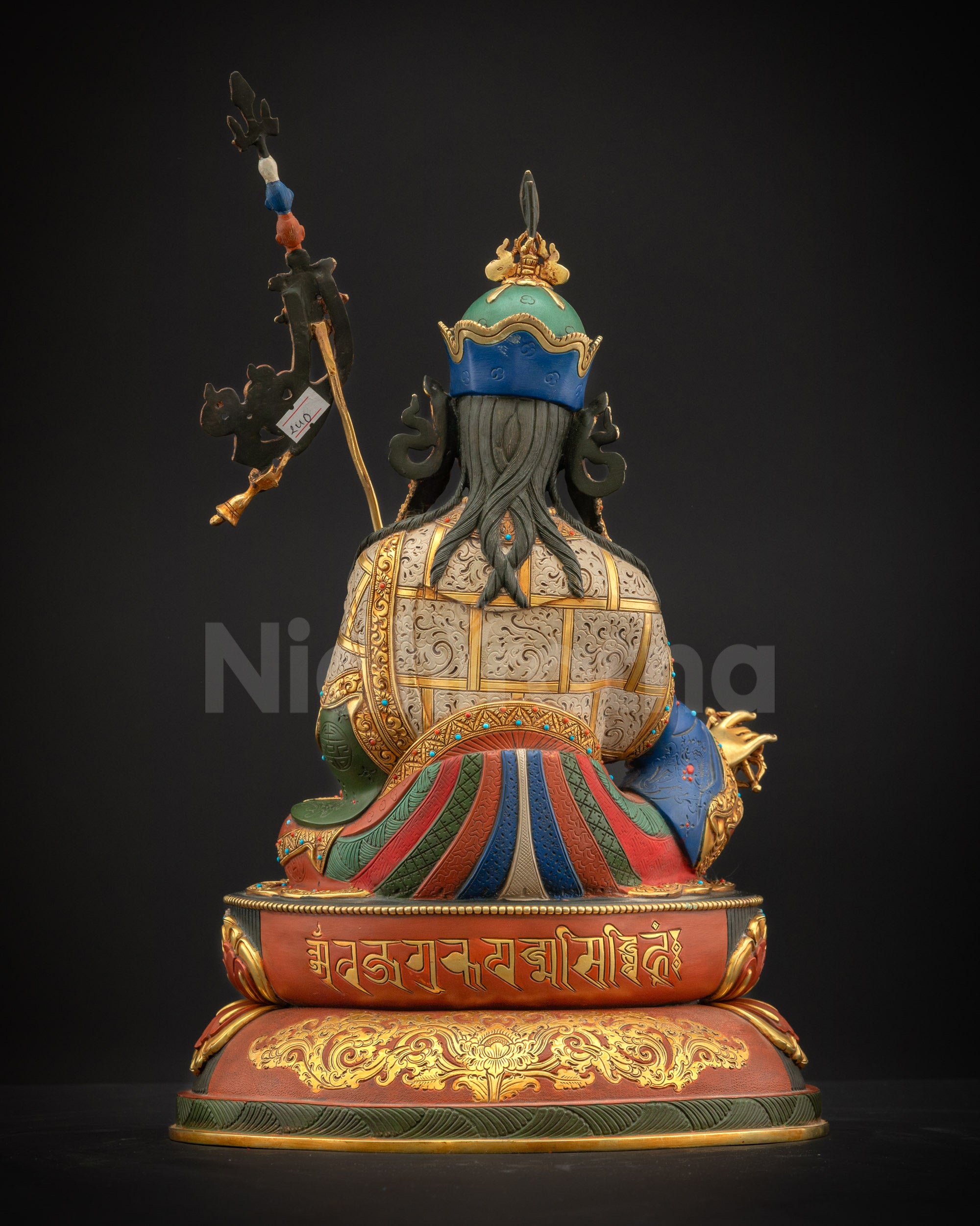 Rear view of Guru Rinpoche statue engraved with Tibetan Uchen mantra for blessings and spiritual practice