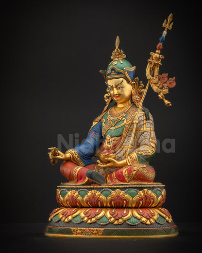 Left-side view of Guru Rinpoche Padmasambhava statue on lotus pedestal holding khatvanga staff, ideal for meditation