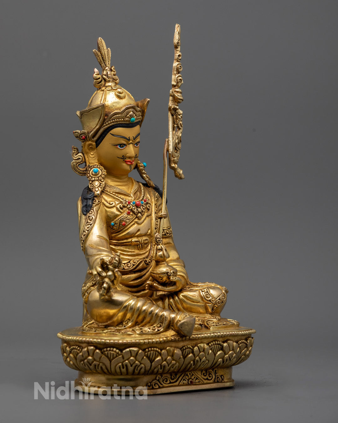 Guru Rinpoche holding a vajra symbolizing compassion and a vase filled with the elixir of immortality, representing healing and longevity