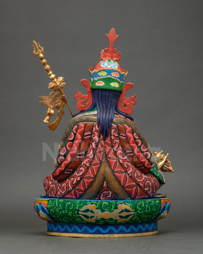 Guru Rinpoche statue back view highlighting carved copper and kasaya folds