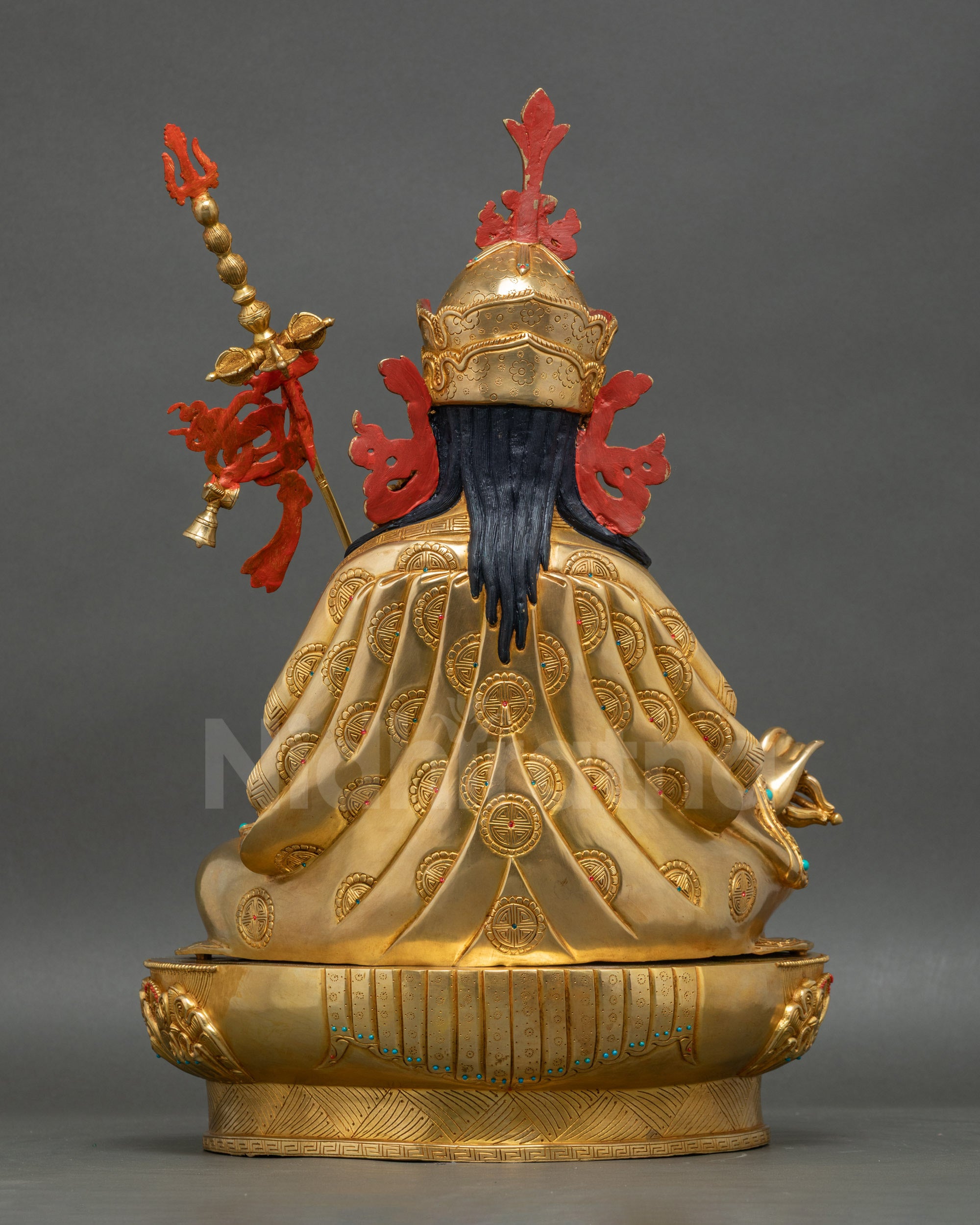 Guru Rinpoche statue back view showing detailed carvings and polished finish
