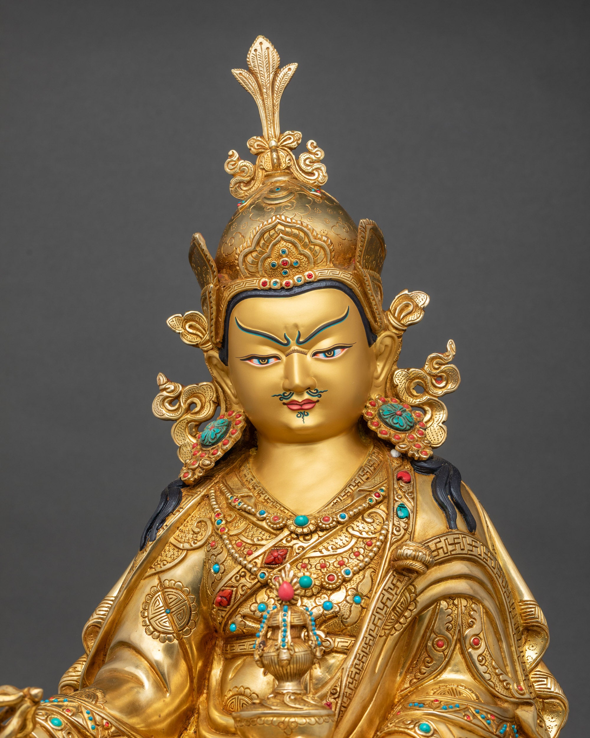 Guru Rinpoche statue close-up showing detailed 3D carvings and fire gilding