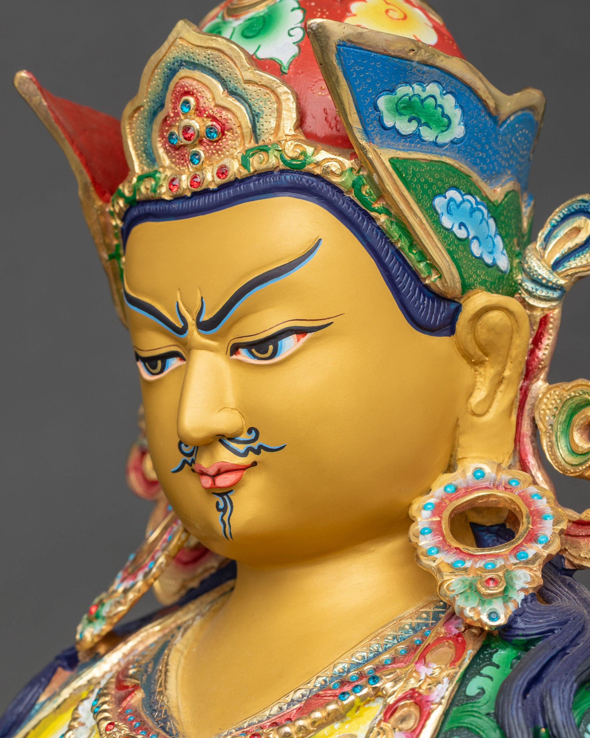 Guru Rinpoche statue detailed side face close up capturing serene expression