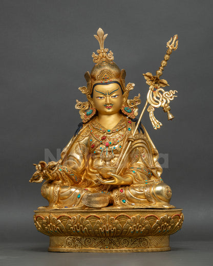 Guru Rinpoche statue front view with gold-painted face and lotus pedestal