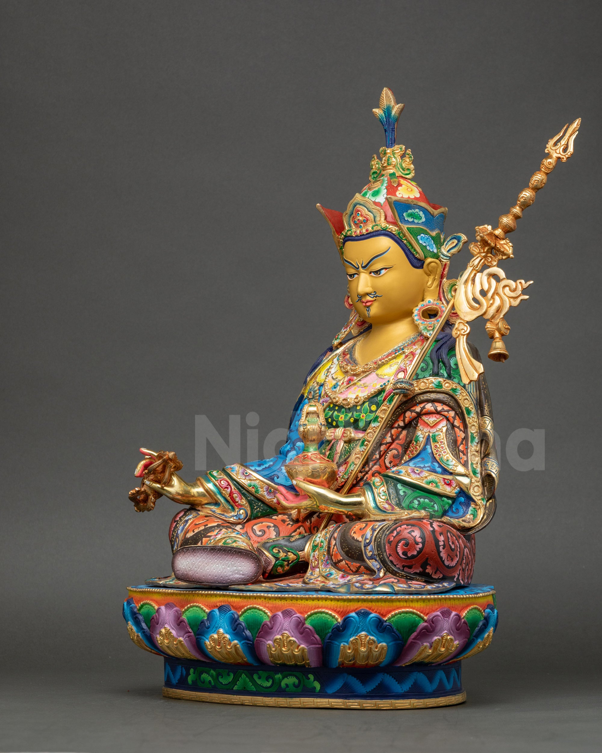 Guru Rinpoche statue right side view showing trident and lotus seat