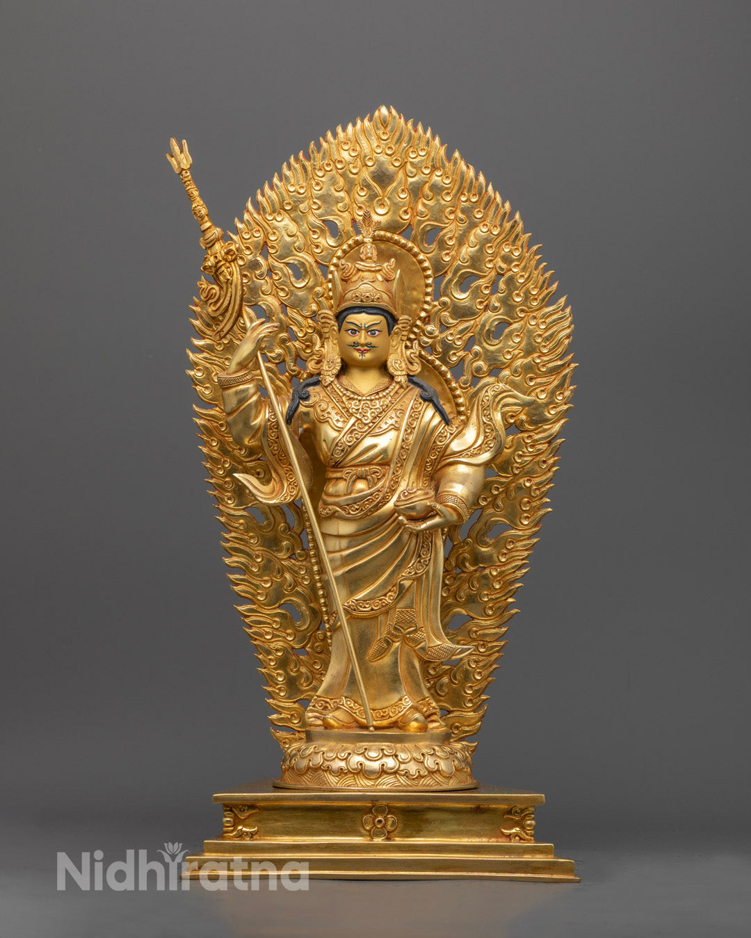 Guru Rinpoche statue showing precise carvings on the crown, halo, and semi-precious stone inlays with vibrant acrylic colors.