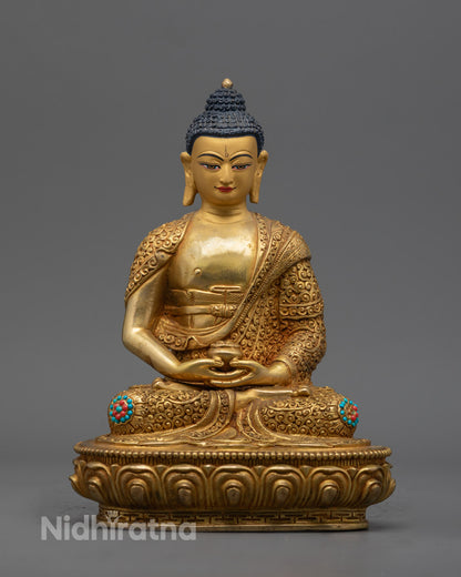 Hand-carved Amitabha Buddha statue with 24k gold fire gilding and semi-precious stones, crafted in Nepal using traditional lost wax method.