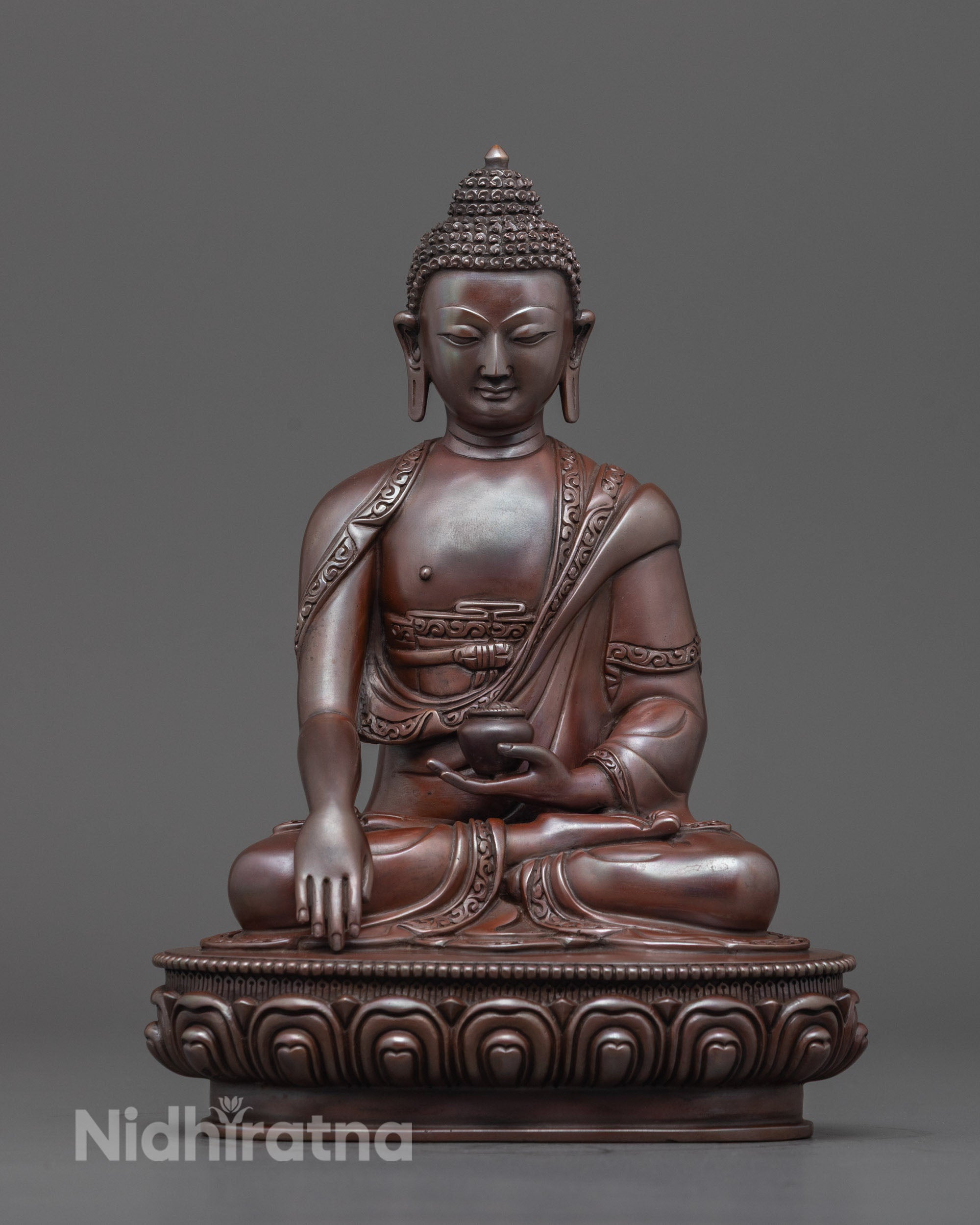 Hand-carved Buddha statue in oxidized copper, seated on lotus base