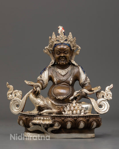 Hand-carved Dzambhala Statue in oxidized copper with silver finish and vibrant acrylic detailing, symbolizing Tibetan deity of wealth and prosperity.