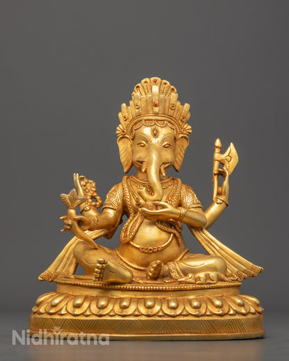 Hand-carved Ganesh statue with 24k fire-gold gilding, crafted by a Nepalese artisan using the traditional lost wax method.
