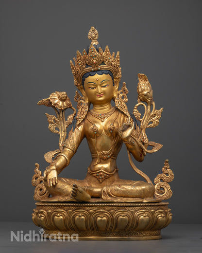 Hand-carved Green Tara Sculpture in 24k gold fire-gilded copper with vibrant multi-colored acrylic details, crafted by Nepalese artisans using lost wax method.