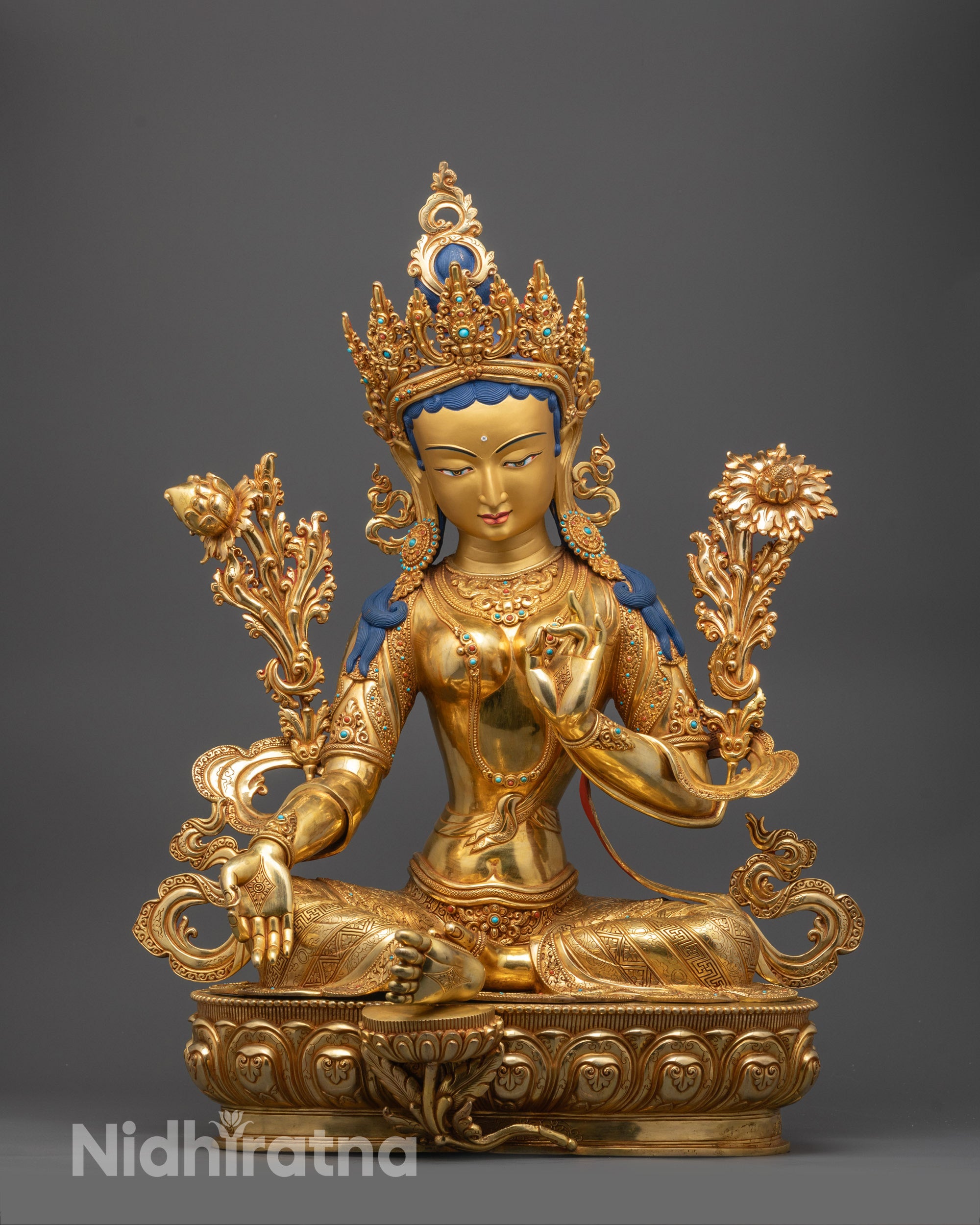 Hand-carved Green Tara Statue seated on lotus base in varada mudra with five-jewel crown