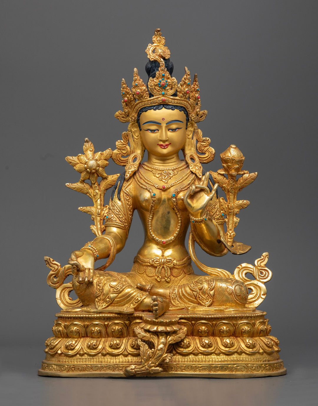 Hand-carved Green Tara Statue with gold fire gilded finish, seated on a lotus throne.