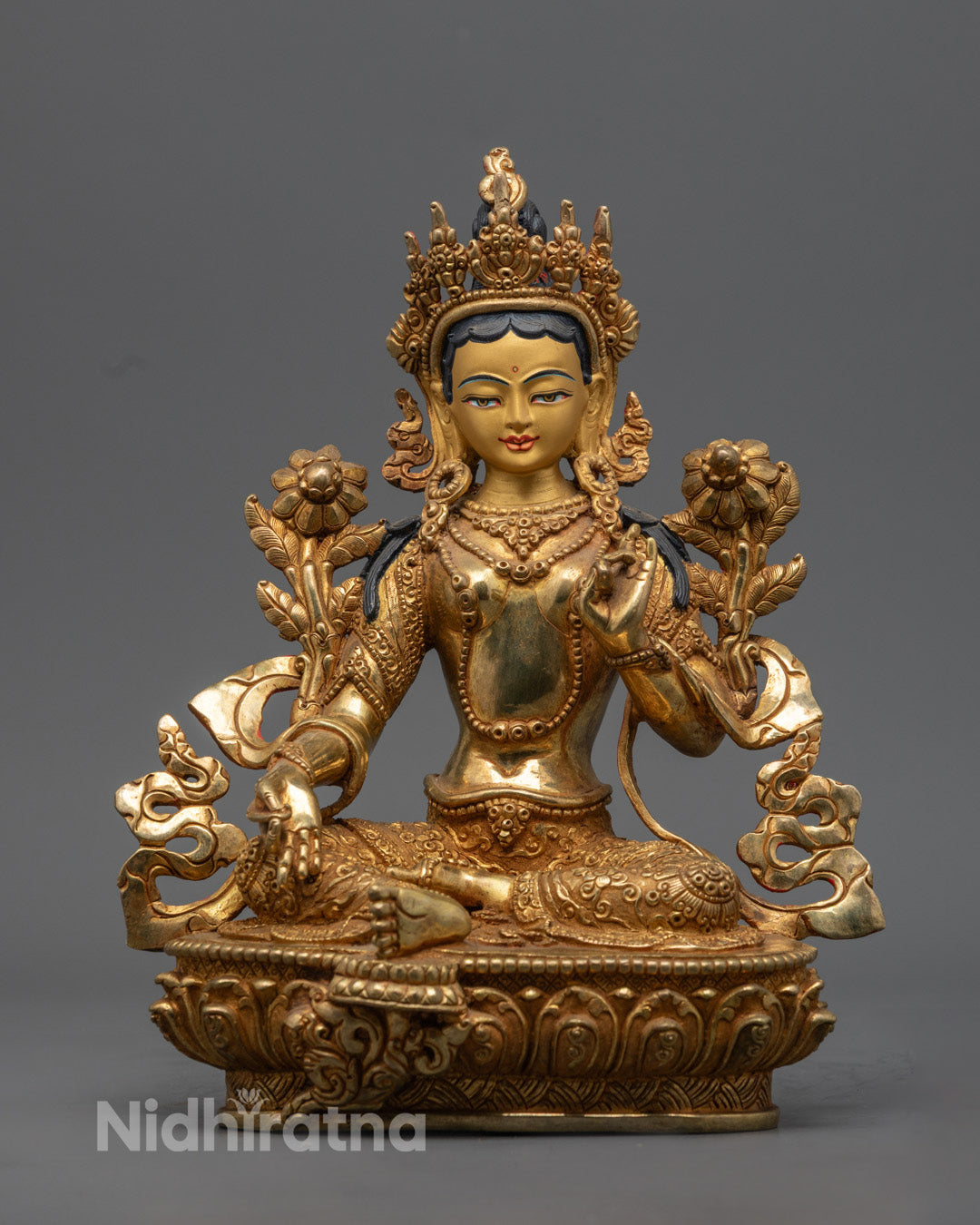 Hand-carved Green Tara statue with 24k gold fire-gilding and semi-precious stones, crafted by Nepalese artisans.
