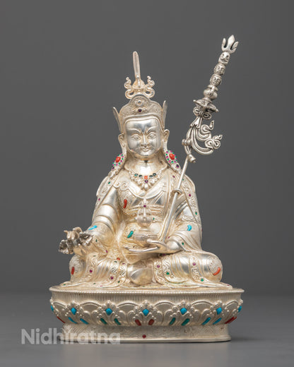 Hand-carved Guru Rinpoche statue adorned with semi-precious stones and silver detailing, crafted using traditional Nepalese lost wax method.