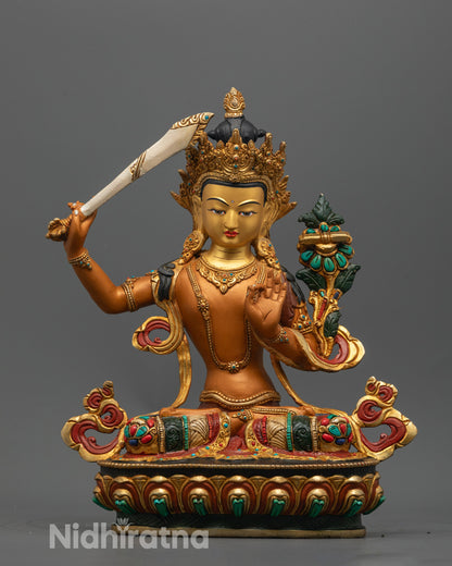 Hand-carved Manjushri Statue with 24k gold-gilded face and orange acrylic body